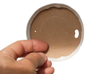 Paper biodegradable lid in the woman's hand. Caution hot contents inscription.