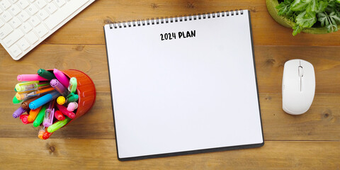 2024 plan on notebook paper background, 2024 new year mock up, template with copy space for text, top view
