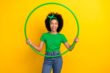 Photo of astonished lovely girl hold training hula hoop unbelievable reaction isolated on yellow color background - obrazy, fototapety, plakaty