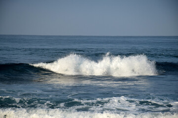 beach waves on a sunny morning, beach waves break the calm on the beach