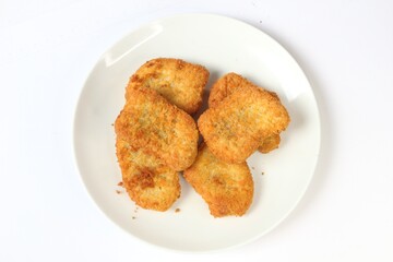 Chicken nuget is served on a plate with a white background