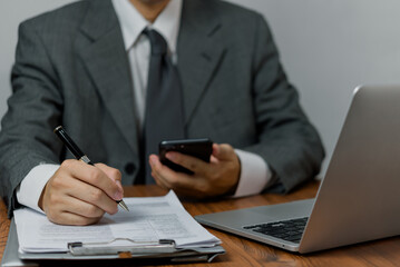 Business person Writing contract law and paper work for business and finance, write document, complete job application forms, contract real estate and insurance concept..