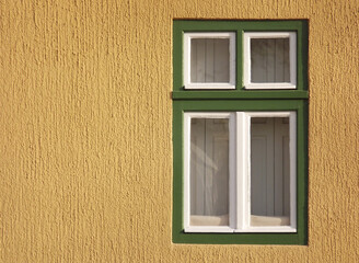 A window with a green frame on a yellow background.