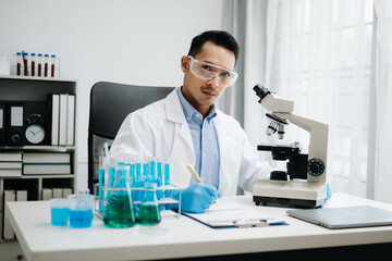 Modern medical research laboratory. male scientist working with micro pipettes analyzing...