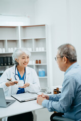 Senior man being examined by a doctor sitting at the table. Medicine and health care concept.