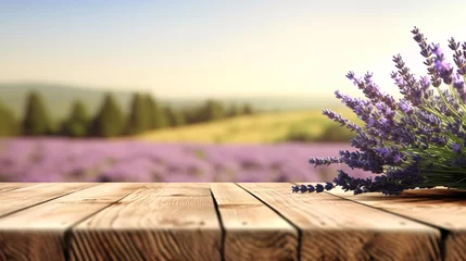 Poster Lavender bouquet on the wooden table at organic lavender farm background. © Sunday Cat Studio