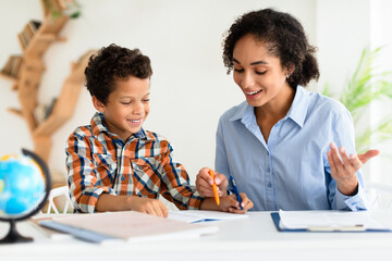 Young School Teacher Lady Teaching Kid Boy, Explaining Lesson Indoor