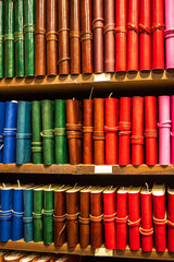 Bookshelves filled with books. Books in colorful leather bindings. Colorful Handmade Notebooks
