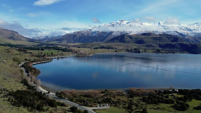 Wanaka, New Zealand: Aerial drone footage of the Glendhu Bay by lake Wanaka with the snow covered Mt Aspiring in New Zealand south island. 