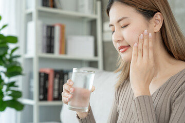 Asian woman feel sensitive teeth after drinking cold, female suffer tooth, decay problems, dental care, tooth extraction, decay problem, bad breath, Gingival Recession, Oral Hygiene instruction