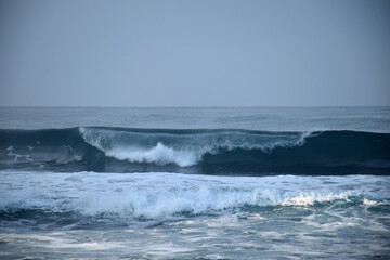 beach waves on a sunny morning, beach waves break the calm on the beach