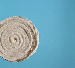 Fototapeta na wymiar Roll of raw dough on blue background, top view, copy space