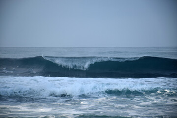 beach waves on a sunny morning, beach waves break the calm on the beach