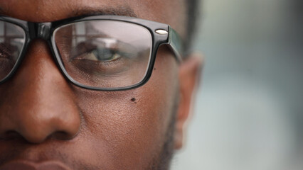 focus on closed eyes of african american man with glasses