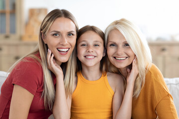 Happy teen girl posing with mom and grandma at home