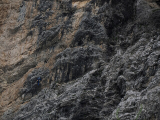 climbers climbing the rocks of monte croce cross mountain in dolomites badia valley panorama landscape