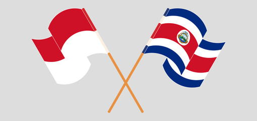 Crossed and waving flags of Indonesia and Costa Rica