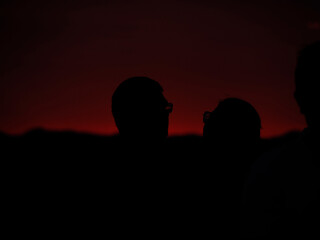 people silhouette photographing red sunset
