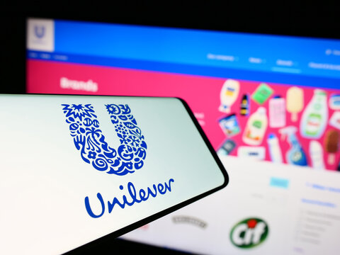 Stuttgart, Germany - 09-19-2023: Cellphone with logo of British consumer goods company Unilever plc on screen in front of business website. Focus on center-left of phone display.