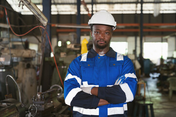 Portrait of african american male engineer worker in industry factory, wearing safety uniform,...