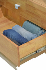Perfect and neatly setting of clothes. Jeans drawer organize isolated on white background. Perfectionist.