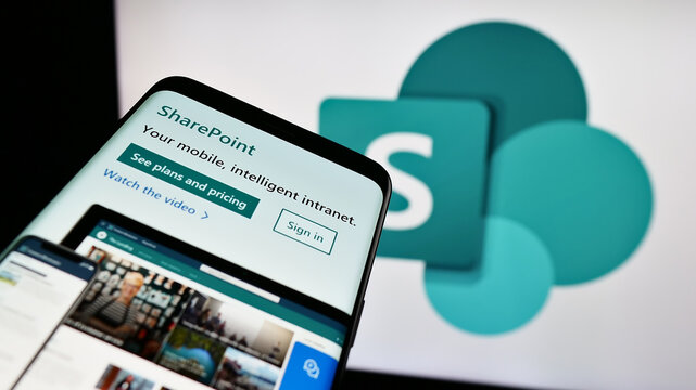 Stuttgart, Germany - 09-21-2023: Mobile phone with webpage of collaborative platform Microsoft SharePoint on screen in front of business logo. Focus on top-left of phone display.