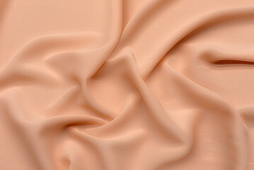 Beautiful smooth and elegant wavy peach orange color satin silk uxury cloth fabric texture,...