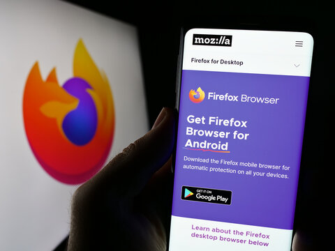 Stuttgart, Germany - 09-22-2023: Person holding cellphone with website of open-source web browser Mozilla Firefox on screen in front of logo. Focus on center of phone display.