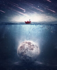 Boy sailing in a paper boat searching for the moon sunken underwater. Satellite drowned in the...