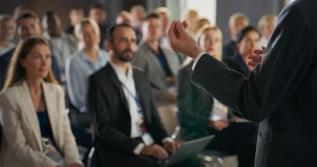 Back View, Focus on Hand Gestures Of Startup CEO Pitching Product Or Service to Room Full of Diverse Investors. Business People Listening To Presentation At International Technology Forum. Slow Motion