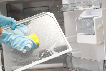 Fototapeta na wymiar Employees use a cloth to clean the refrigerator.