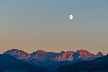 Beautiful waning moon over the wägital mountains, canton Schwyz, Switzerland. View from the Seedam...