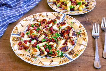A traditional Polish cuisine dish: potato dumplings with bacon and onion