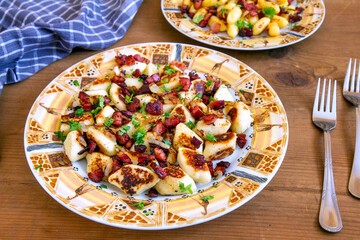 A traditional Polish cuisine dish: potato dumplings with bacon and onion