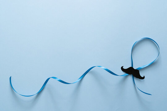 Movember concept - event to raise awareness of men's health issues, moustache anf blue ribbon