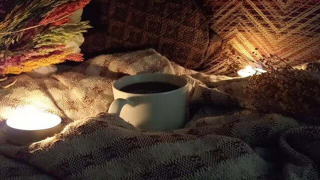 Drinking coffee by candlelight at night. Candles burning in the dark.