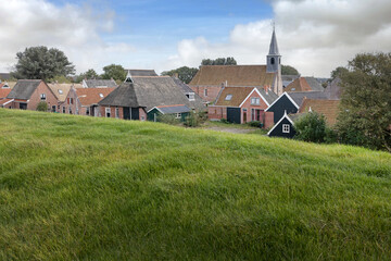 Fototapeta na wymiar Village of Paesens. Moddergat. Friesland Netherlands. Waddenzee. Coast . Dike. 