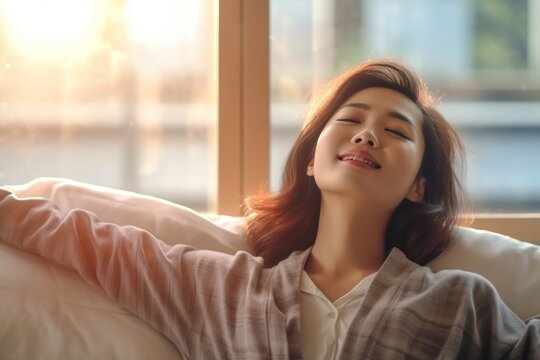 Beautiful young asian woman in pajamas stretching on bed in the morning. generative ai	
