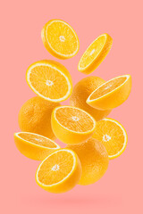 Bright oranges closeup levitation as flow, art composition. Whole, half, round slices fruits on pastel pink background, shadow. Summer fruits for advertising, design, label product, poster, card.