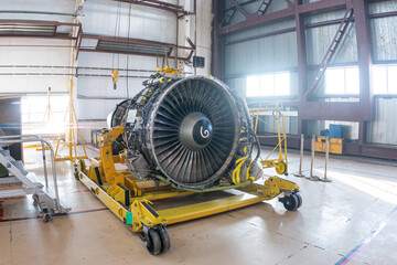 High-bypass turbofan airplane engine in aviation hangar