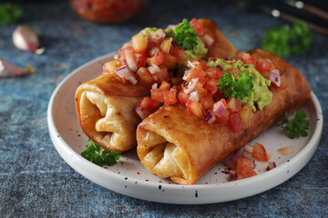 A typical dish of Mexican cuisine - Chimichanga, made of tortilla with different ingredients	