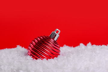 Christmas decorations on snow with red background, copy space.Christmas concept