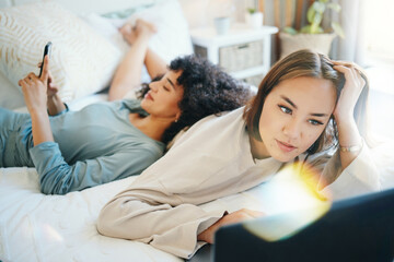 Laptop, social media and morning with a lesbian couple in bed together in their home on the weekend. Diversity, computer and an lgbt woman browsing with her girlfriend in the bedroom for love