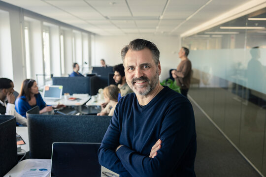 Portrait of team leader standing in office