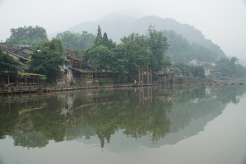 Dense vapours shrouding a wooden historic town in ancient China.