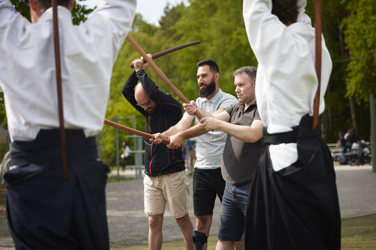Men with disabilities learning how to use katanas