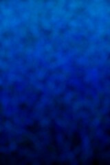 Blue wallpaper, bokeh style. Colour transition from light blue to dark blue. Blurred patches in different shades of blue.