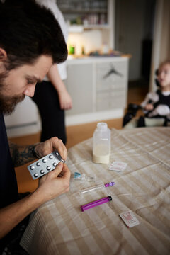 Man preparing nutrition for feeding tube for disabled child