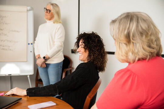 Smiling businesswoman sitting during business meeting