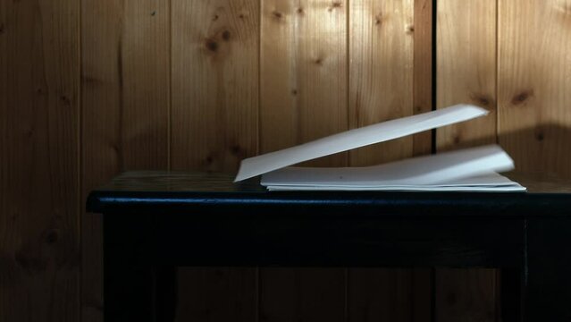 Stack of paper blowing in the wind